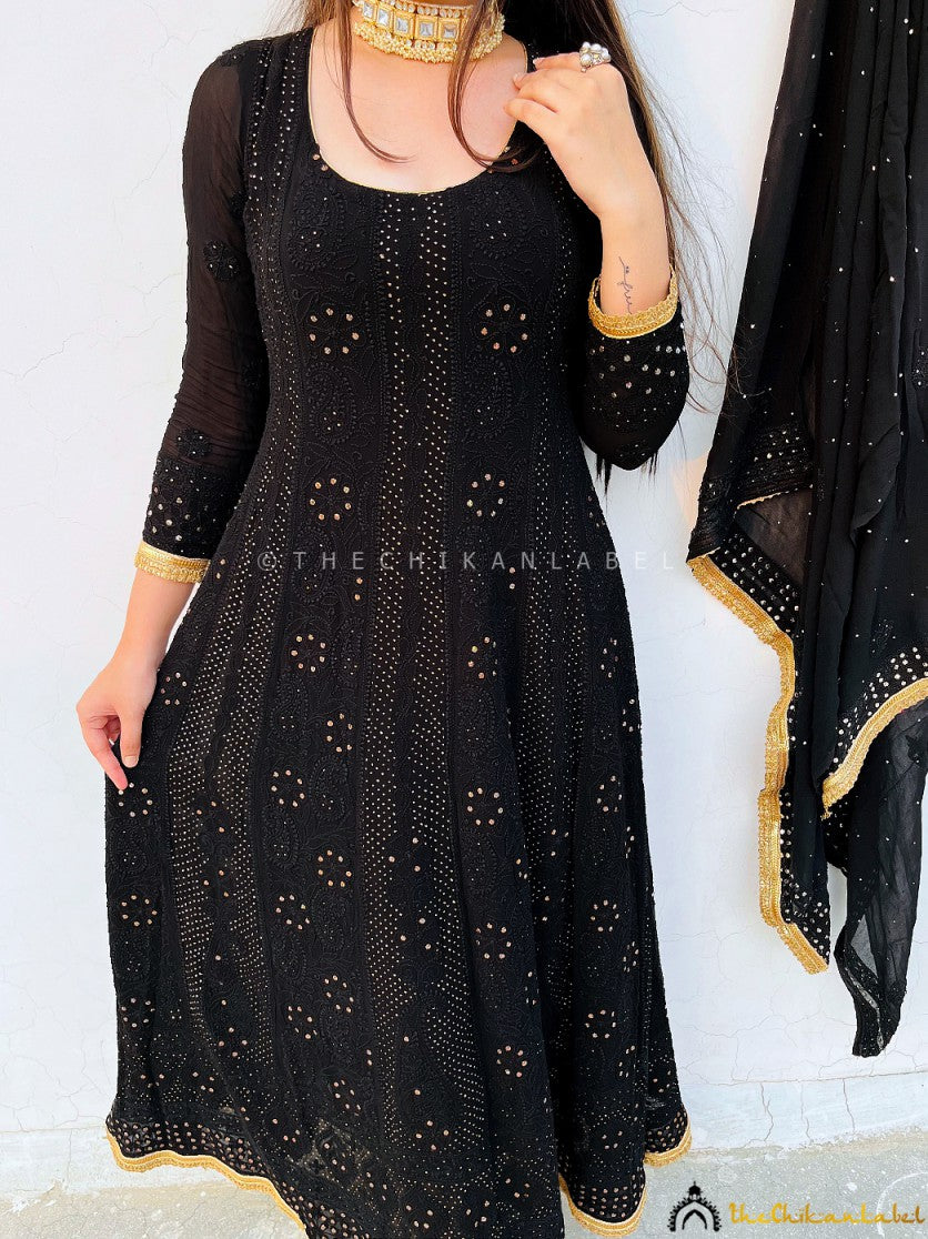 Stylish festive wear Anarkali captured with floral decor in a rooftop evening celebration setup