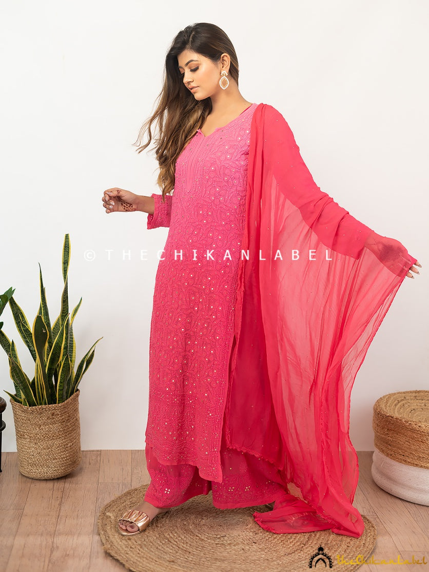 Model posing in luxury viscose ethnic set with white chikankari detailing and mukaish embroidery on dupatta.