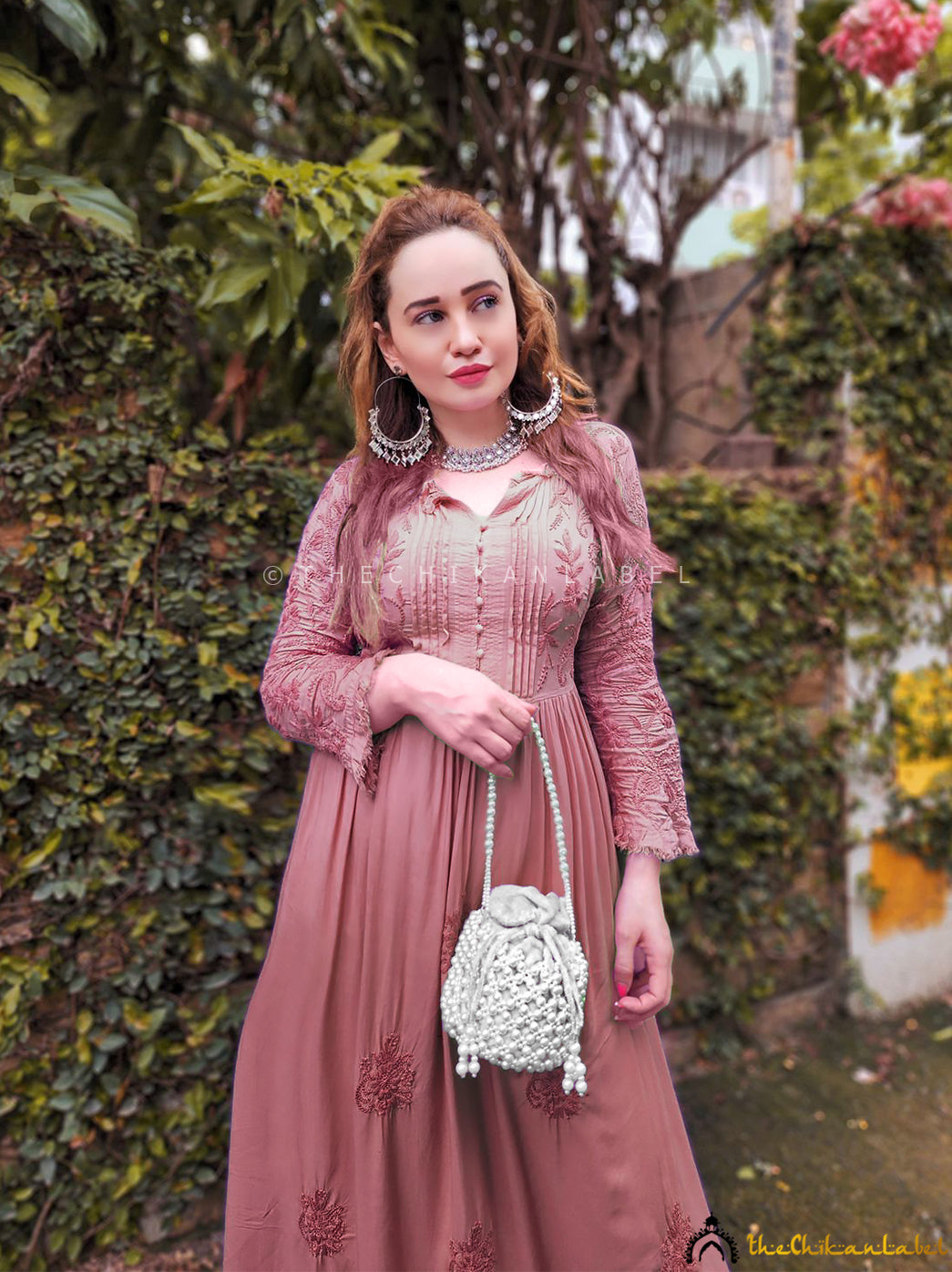 Woman wearing Titli Muslin Chikankari Anarkali in chocolate brown, featuring intricate hand embroidery and flared silhouette.