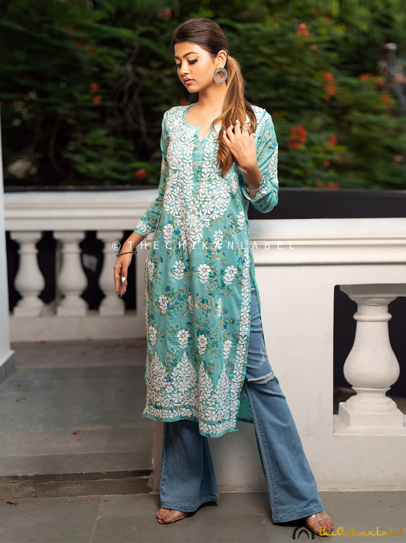 Woman wearing a green chikankari kurti in breathable mulmul cotton.