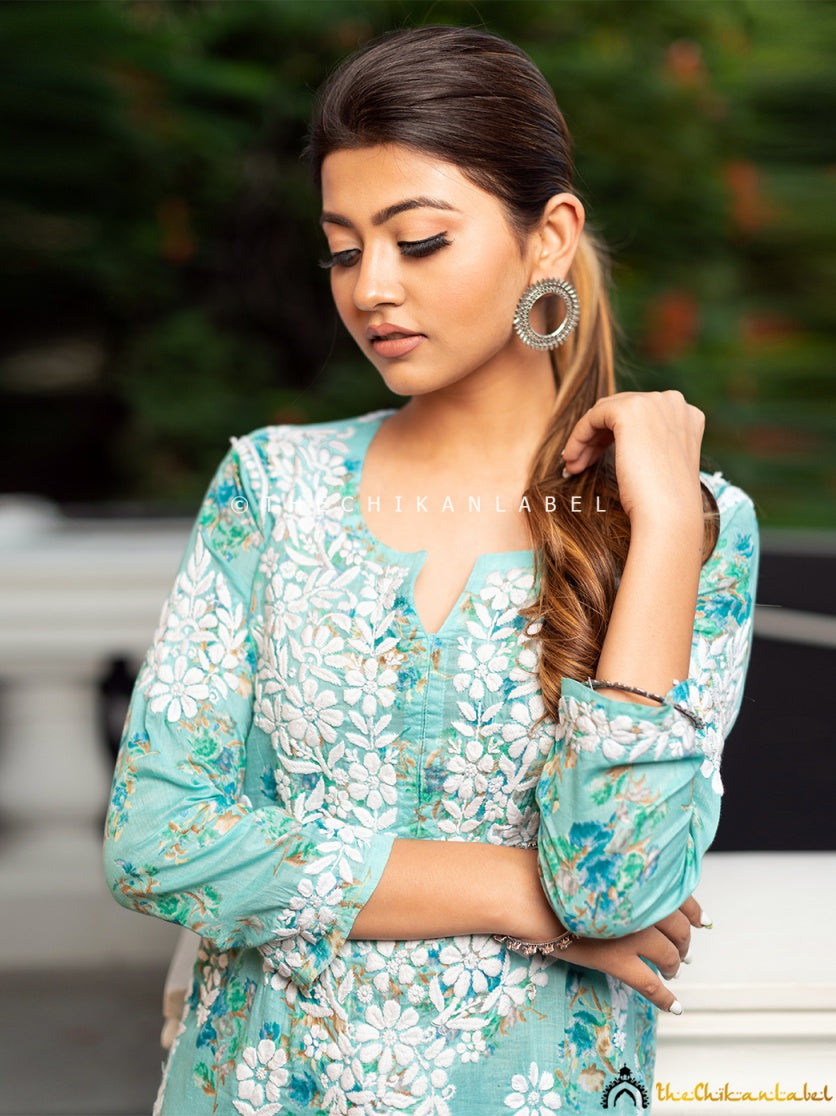 Styled with flared denim jeans for a modern fusion look.