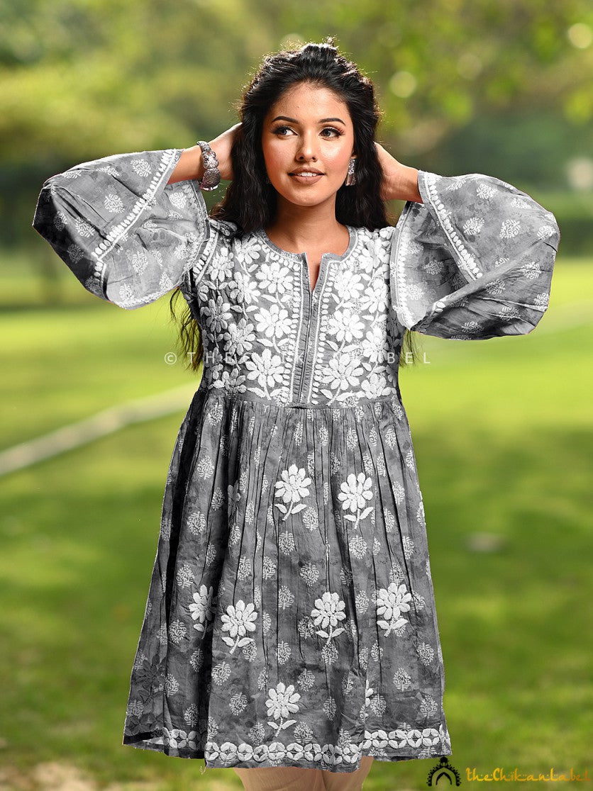 Woman wearing grey chikankari peplum top with bell sleeves
