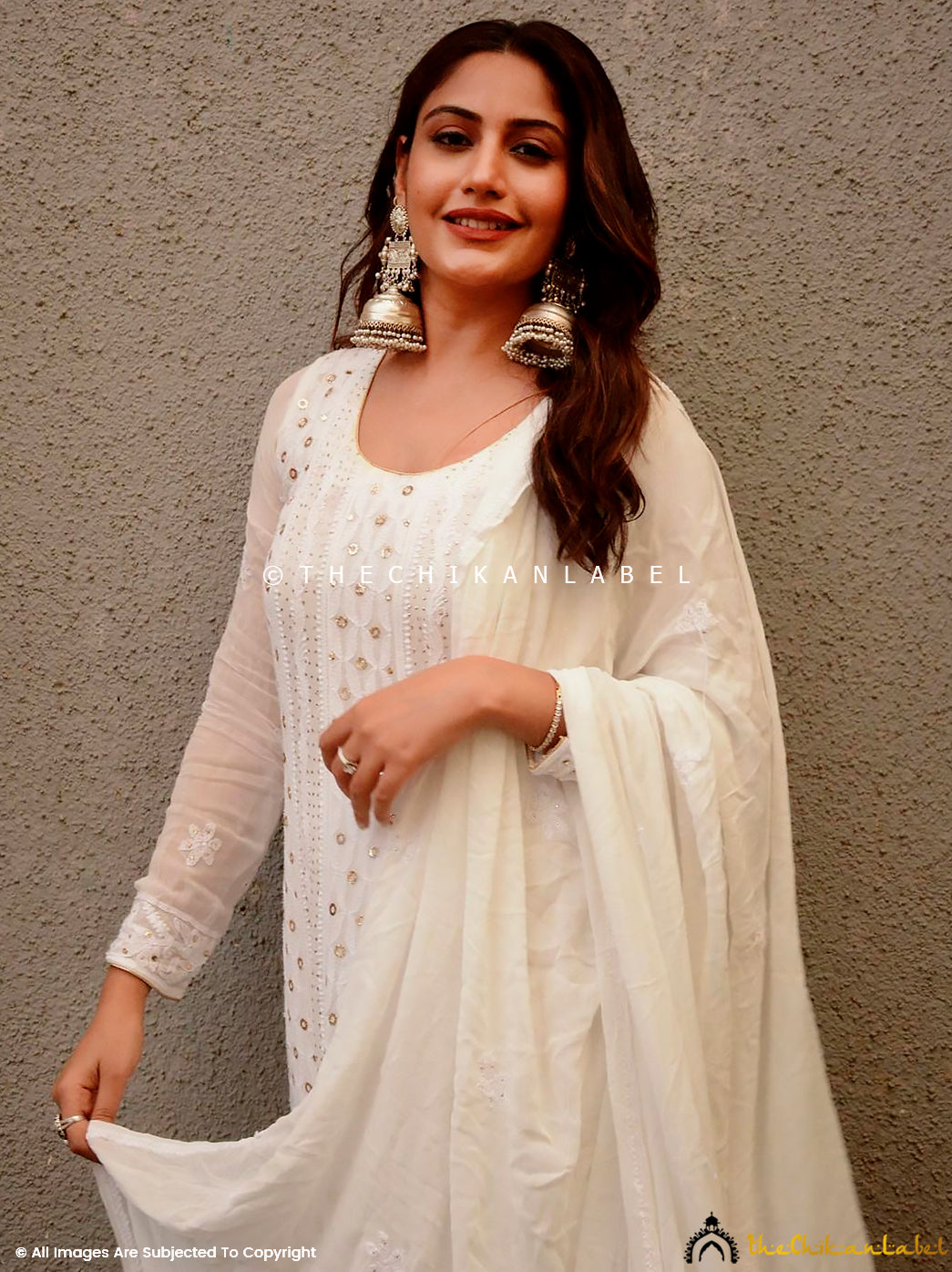 Festive and wedding wear anarkali made of soft viscose fabric with artisanal chikankari work, paired with a flowing dupatta