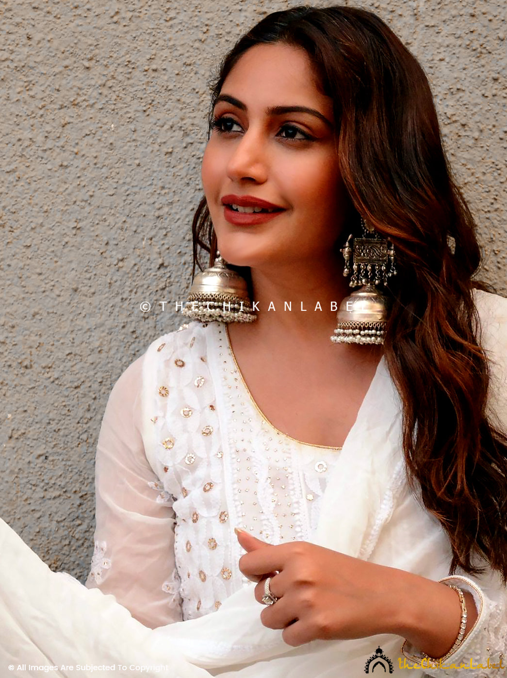 Elegant chikankari anarkali styled with ethnic jewelry and heels, showcasing handcrafted floral embroidery