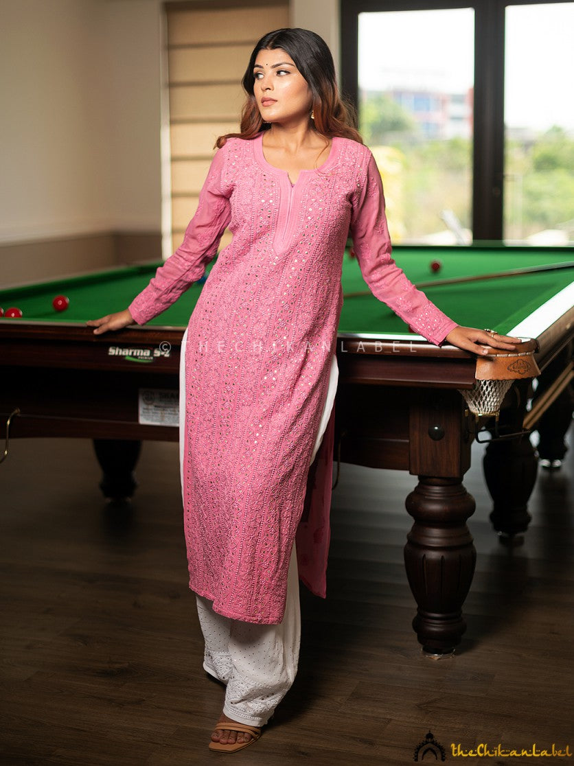 Model posing indoors in soft pink kurti with elegant everyday styling