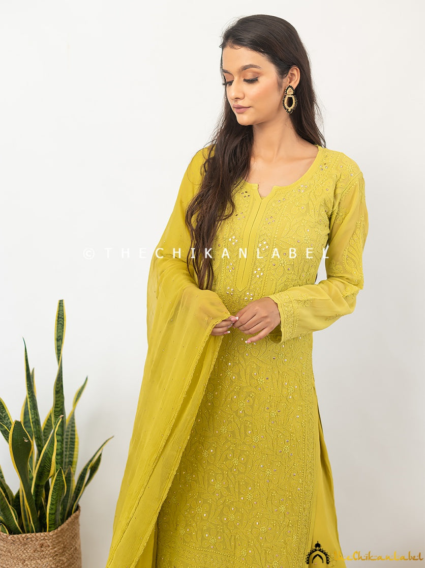 Full-body shot of a model wearing a mukaish-enhanced chikankari viscose kurti palazzo set styled for a luxury ethnic event.