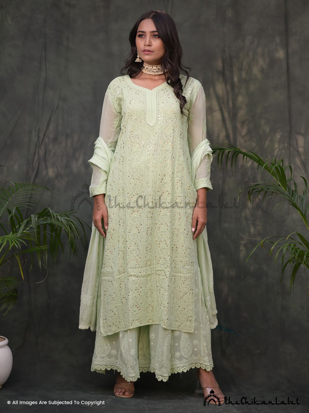 Woman wearing pista green chikankari kurta set with dupatta