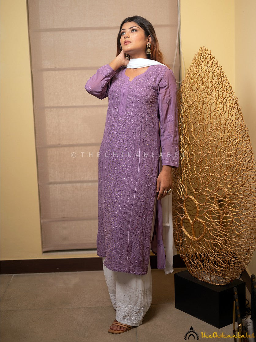 Model twirling in purple chikankari kurti, showcasing flowy viscose fabric and intricate hand embroidery.