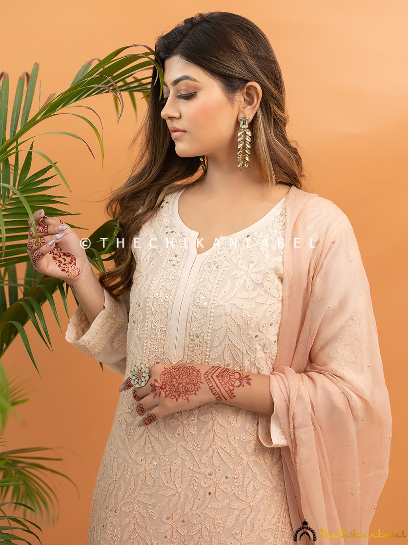 Traditional mukaish and chikankari work on viscose kurti set worn for ethnic gatherings and weddings.