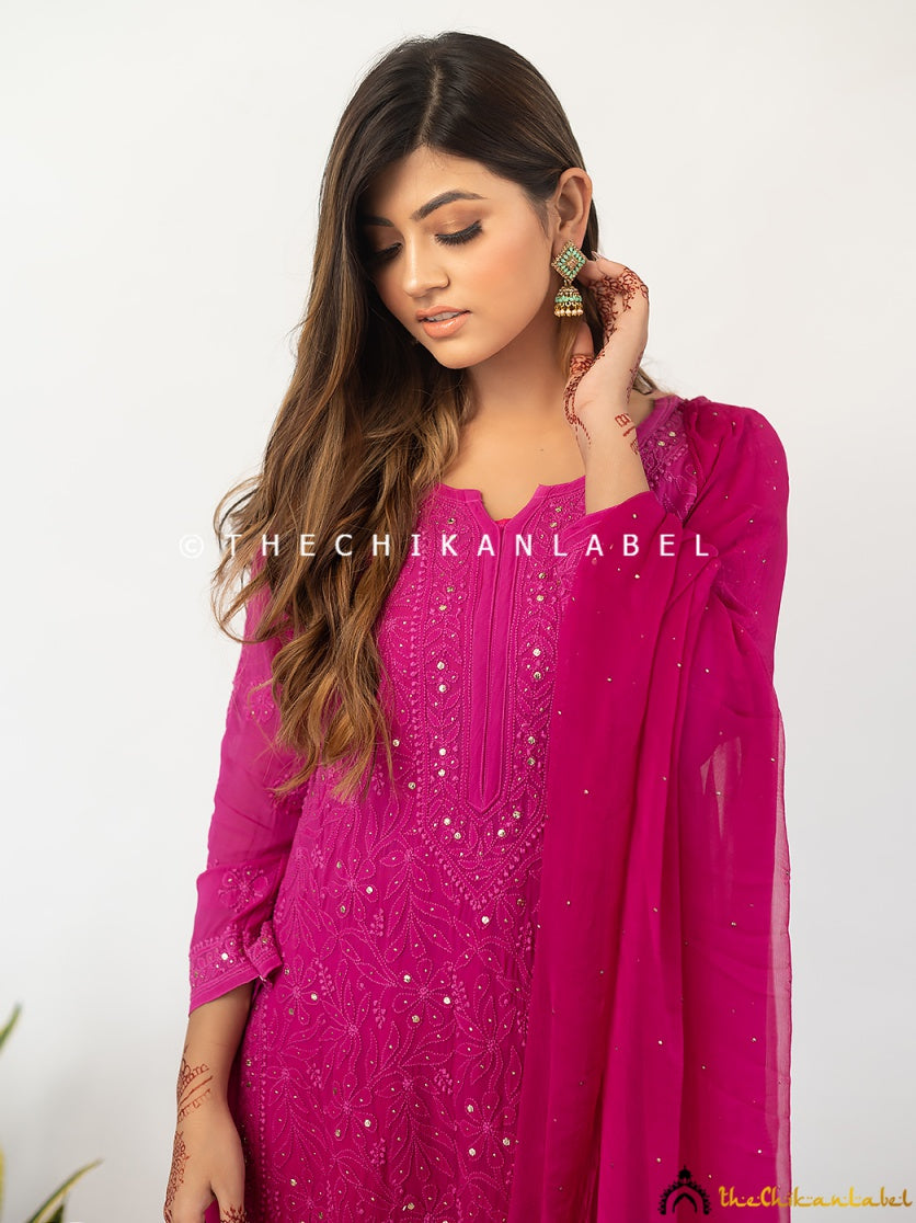 Model twirling in a chikankari viscose kurti palazzo outfit, enhanced with metallic mukaish embellishments and classic ethnic silhouette.