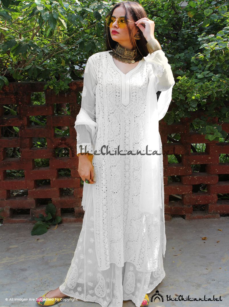 Front view of model in white chikankari kurta set with mirror accents and matching dupatta.