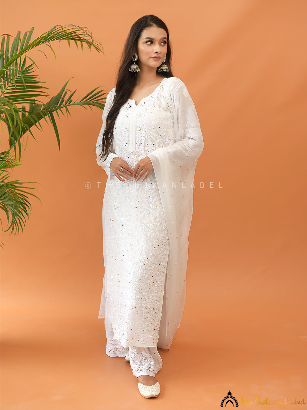 Traditional chikankari kurti palazzo set in viscose fabric, featuring sheer dupatta and mukaish accents for festive styling.