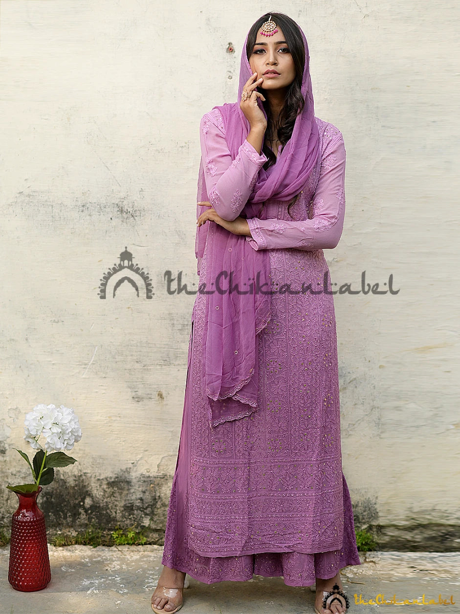 Model wearing purple chikankari kurta set with dupatta draped over both shoulders, showcasing mirror work and coordinated festive styling.