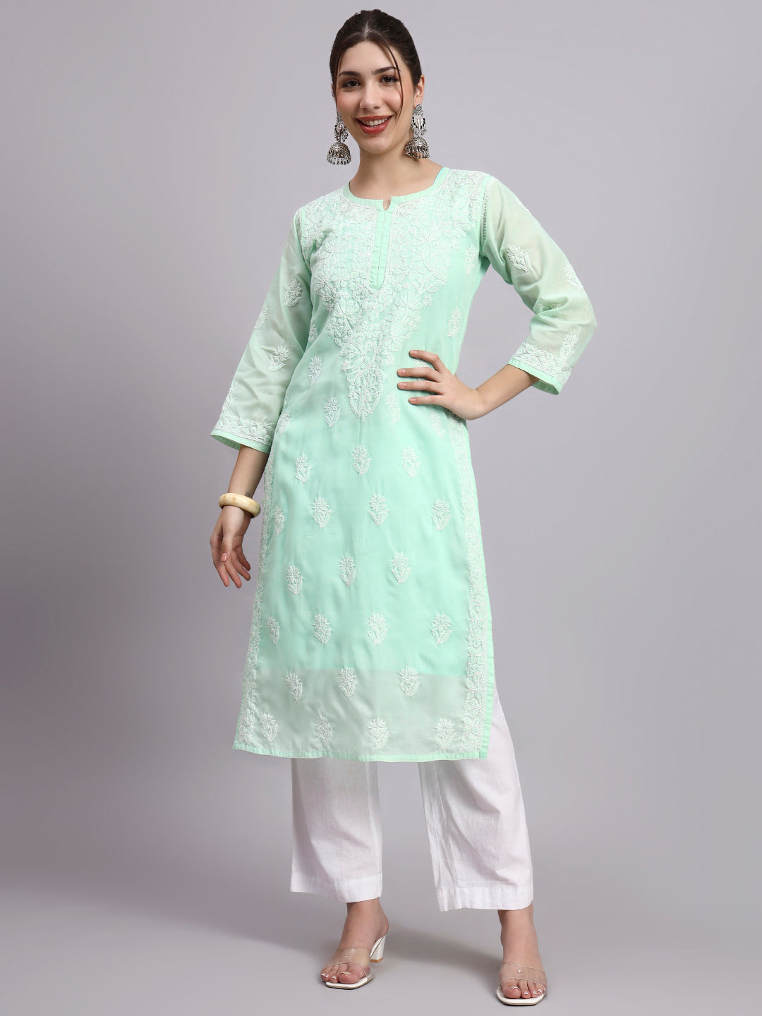 Woman wearing Chikankari cotton kurti with straight silhouette and intricate hand embroidery suitable for comfortable regular wear