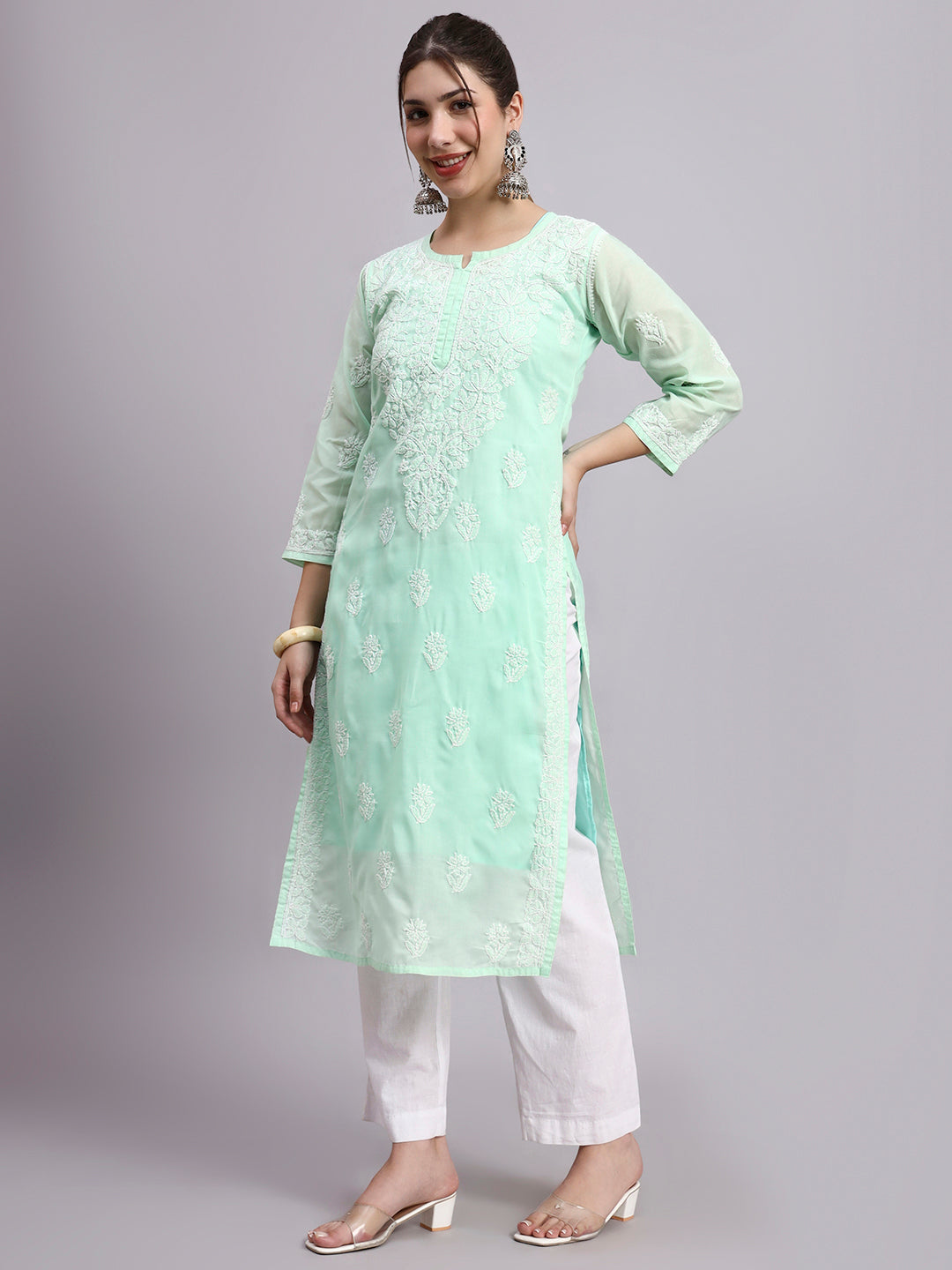 Trending women kurta featuring cotton fabric and detailed Chikankari work styled with minimal accessories for everyday fashion