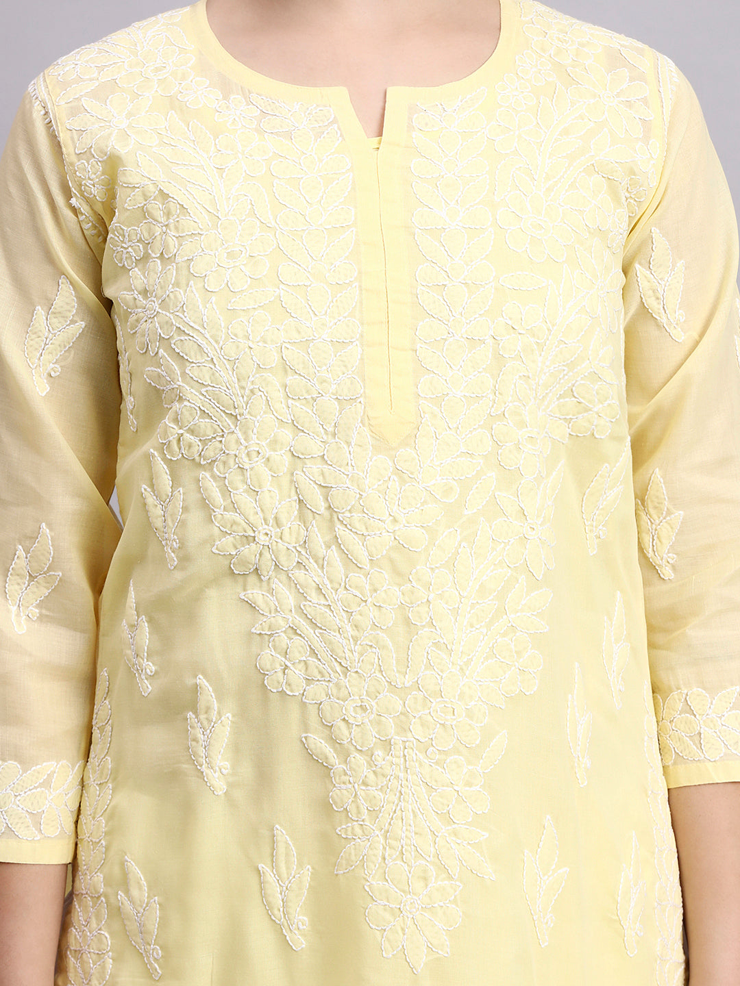 Trending women kurta featuring cotton fabric and detailed Chikankari work styled with minimal accessories for everyday fashion