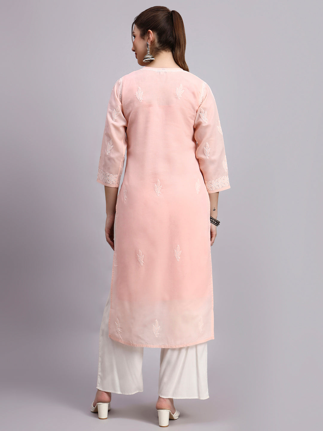 Woman wearing Chikankari cotton kurti with straight silhouette and intricate hand embroidery suitable for comfortable regular wear