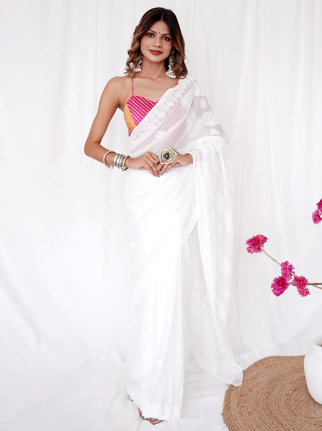 Woman draped in handcrafted Kota Doria saree featuring traditional chikankari embroidery and paired with statement jewelry.

