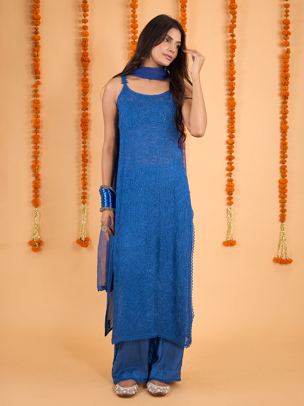 Model wearing the Adaah viscose straight sleeveless strappy kurti palazzo set with dupatta, featuring floral Chikankari embroidery and delicate lace edging.
