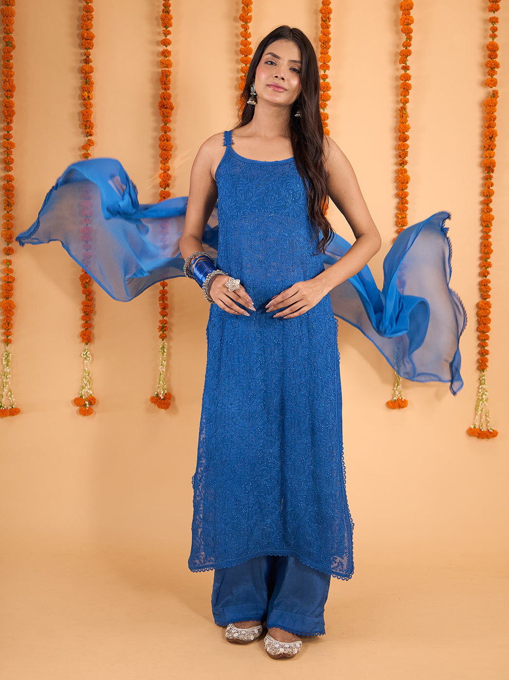 Adaah three-piece Chikankari outfit featuring a long sleeveless kurti, coordinating palazzo pants and a sheer dupatta with a delicate border.