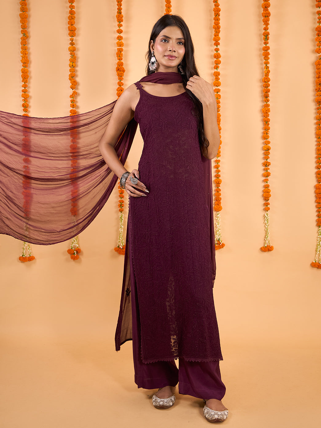 Adaah festive wear set on a model, showing the long floral embroidered kurti, slim shoulder straps, relaxed palazzo pants and softly draped dupatta.