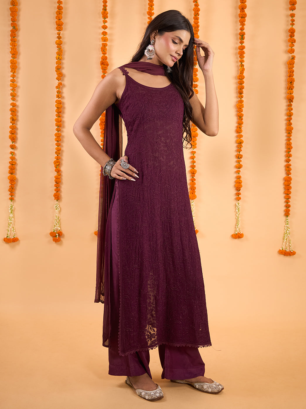 Coordinated Chikankari strappy kurta set featuring an embroidered straight kurti over flowing palazzo pants, with lace accents finishing both garments.
