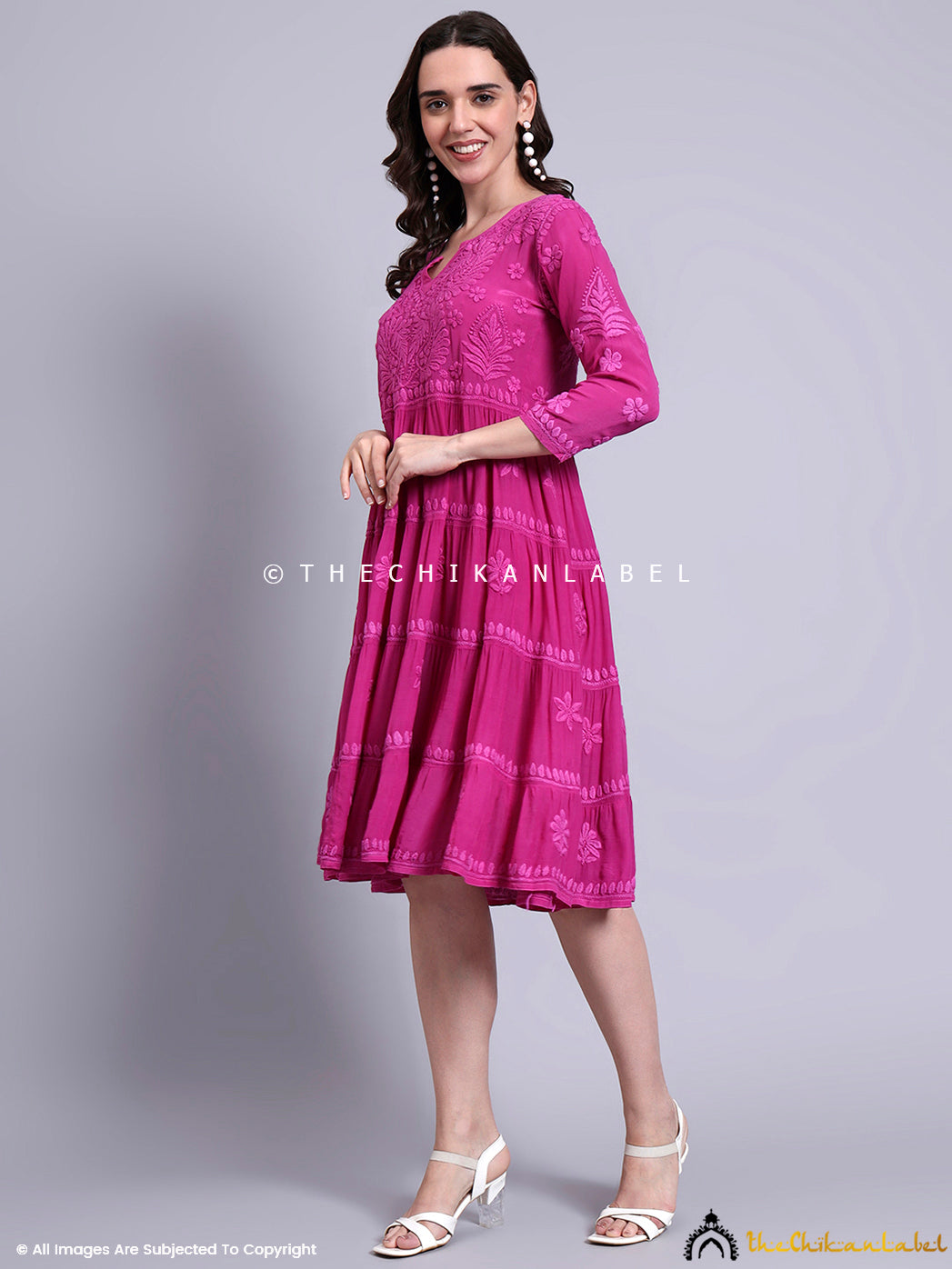 Flowing tiered gown with intricate hand embroidery styled as a modern ethnic tunic dress.

