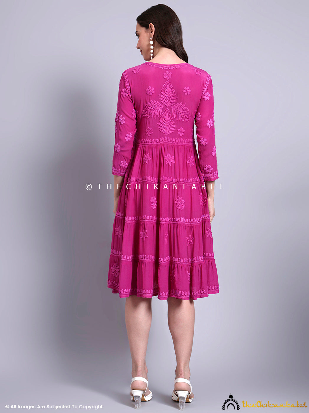 Model showcasing traditional chikankari work on crepe tunic gown paired with elegant heels.

