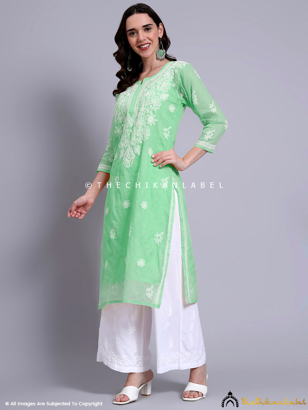 Traditional Indian outfit featuring a straight-cut kurti with notched round neckline and intricate hand-embroidered chikankari motifs.

