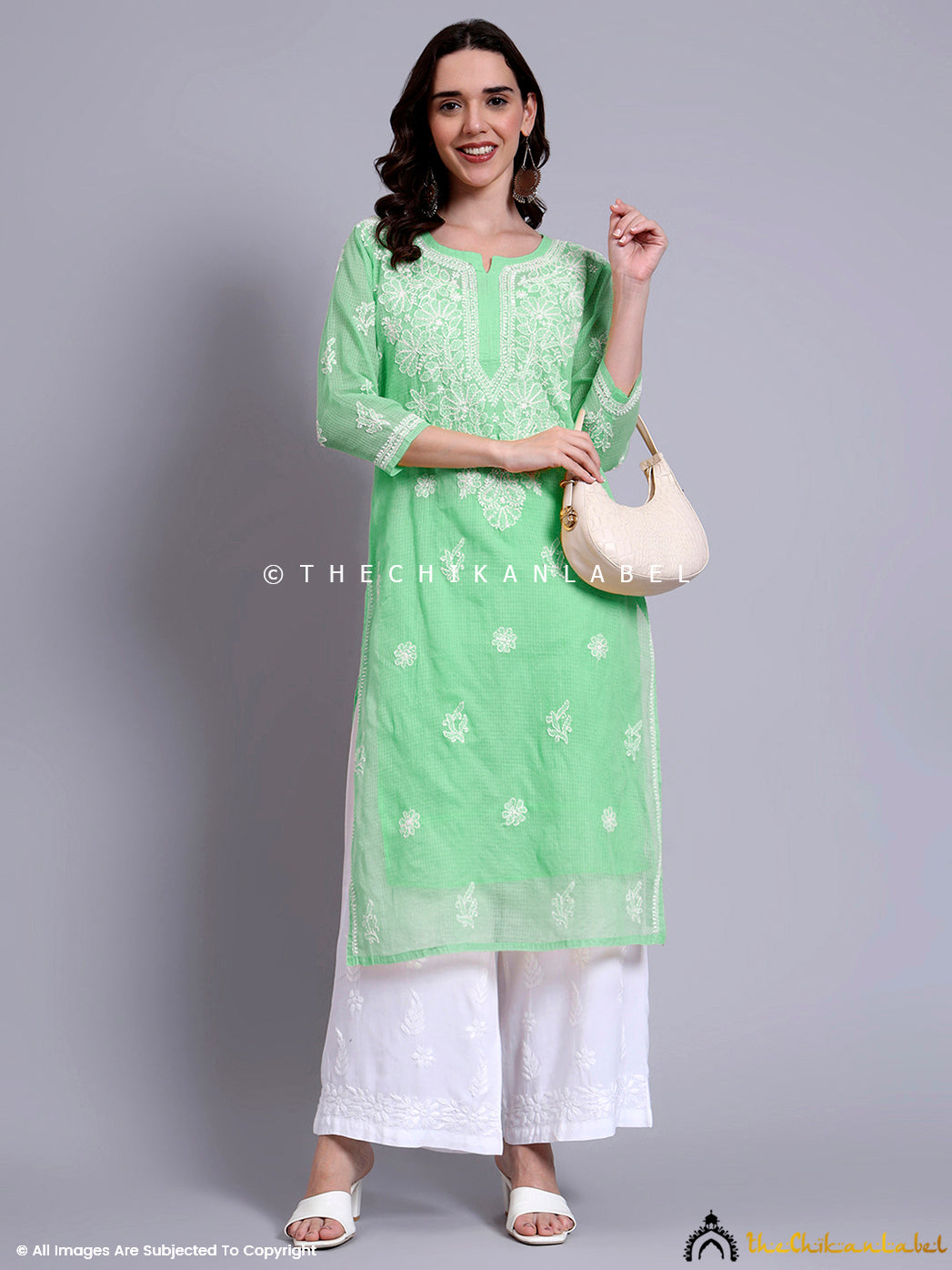 Ethnic look featuring a long straight kurti with handcrafted embroidery, lightweight cotton fabric, and side slits for easy movement.


