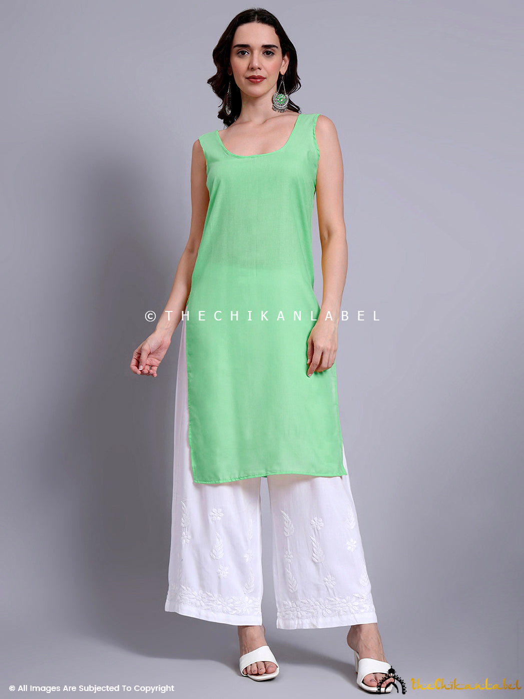 Daily wear kurti with inner lining, made from soft Kota cotton and adorned with scattered chikankari floral patterns on the front and sleeves.

