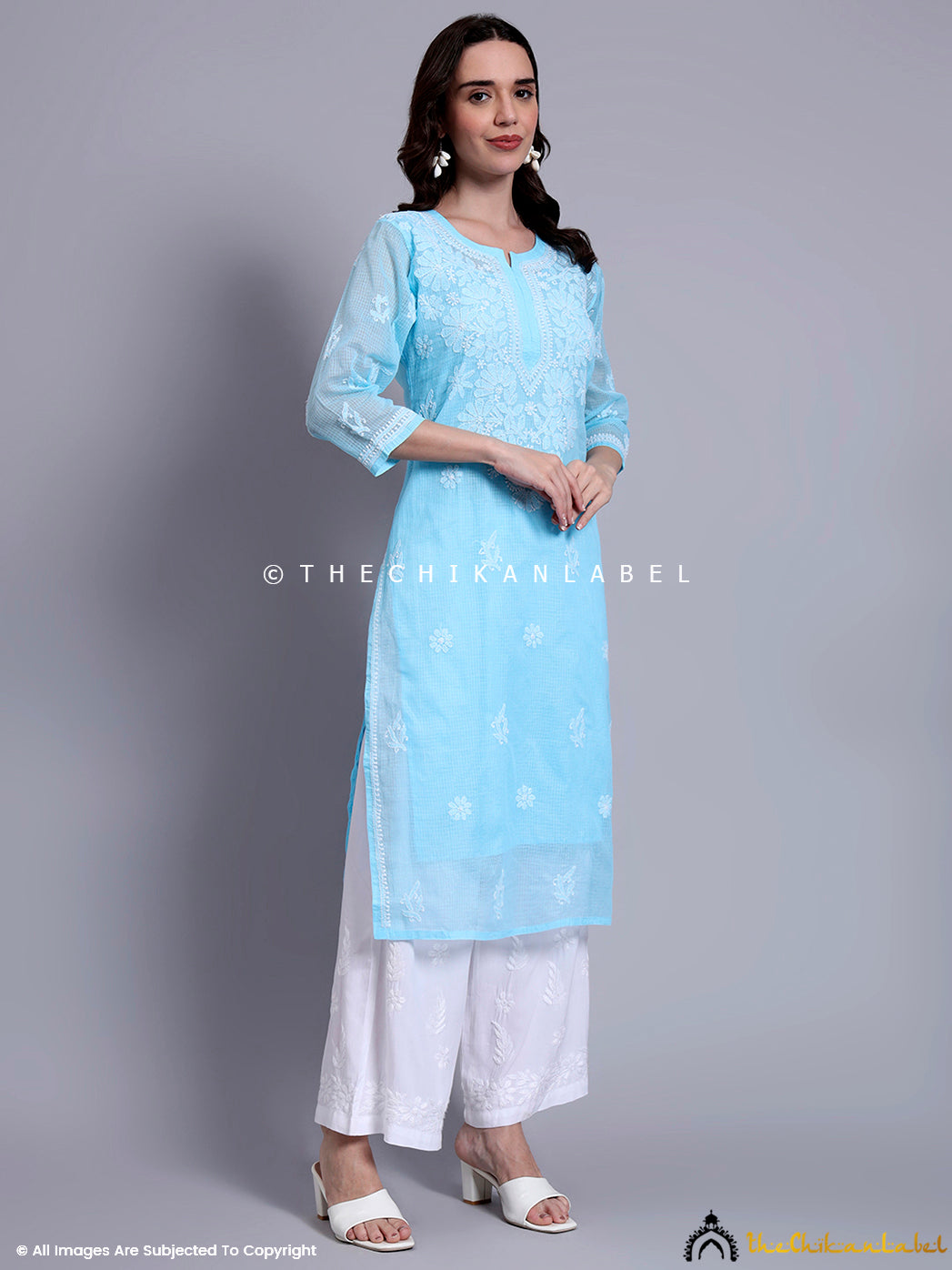 Model wearing hand-embroidered Kota cotton kurti with relaxed straight fit and embroidered three-quarter sleeves for summer wear.

