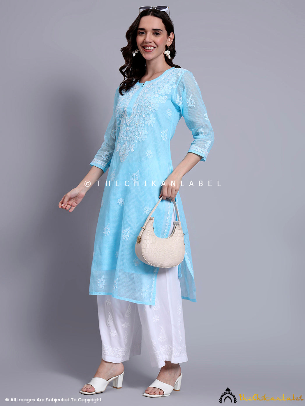 Ethnic kurti featuring Lucknowi chikankari motifs on airy cotton fabric, styled for modest dressing with stitched inner lining.

