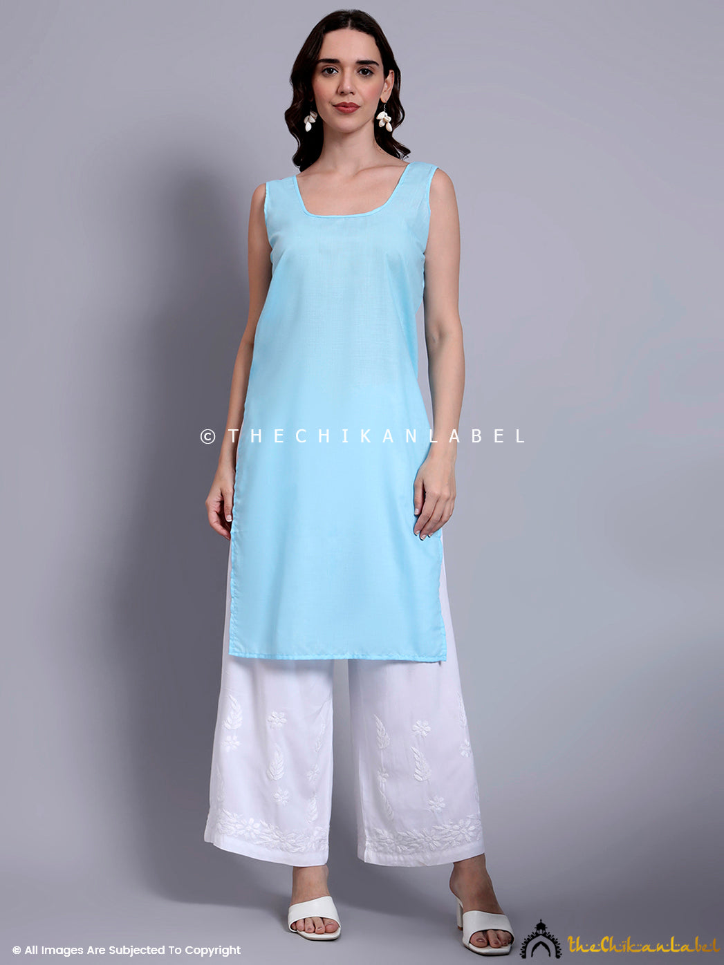 Modern Indian outfit with chikankari detailing on a straight-fit Kota cotton kurti, designed for hot weather comfort and breathability.

