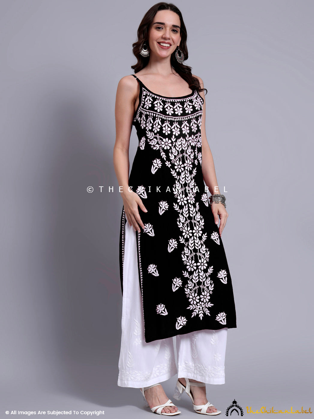 Casual festive look with modal strappy kurta featuring chikankari craftsmanship, paired with minimal jewelry and white bottoms.

