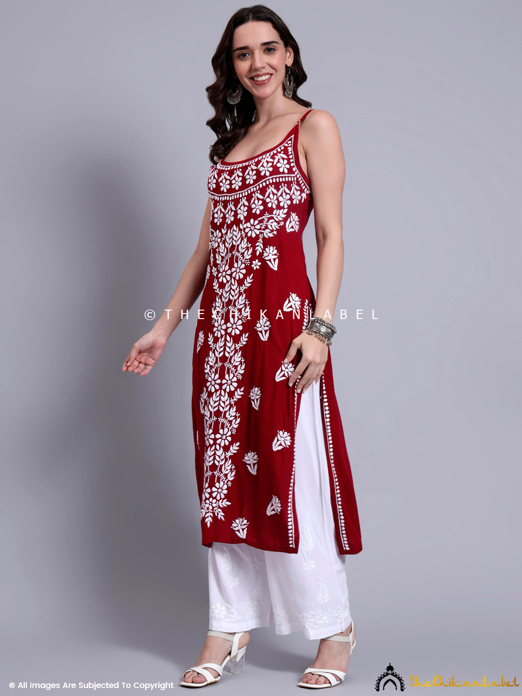 Elegant kurta design with thin shoulder straps, chikankari embroidery, and modal fabric finish, offering a graceful yet contemporary look.


