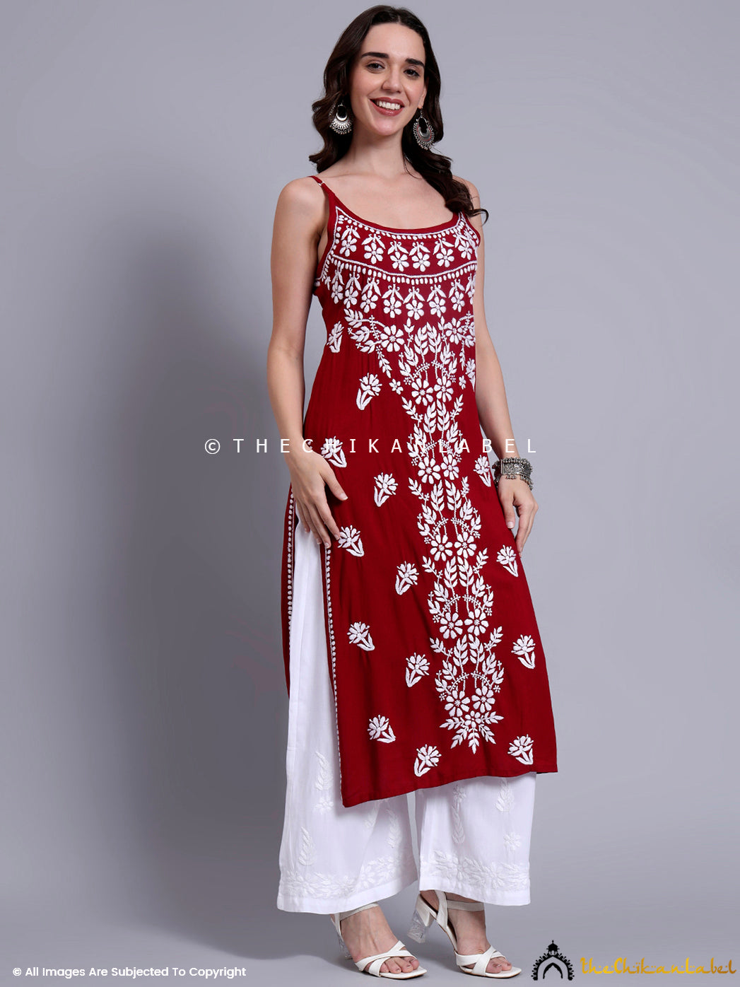 Trendy ethnic look with long chikankari kurta made in modal material, paired with wide-leg pants and traditional earrings.

