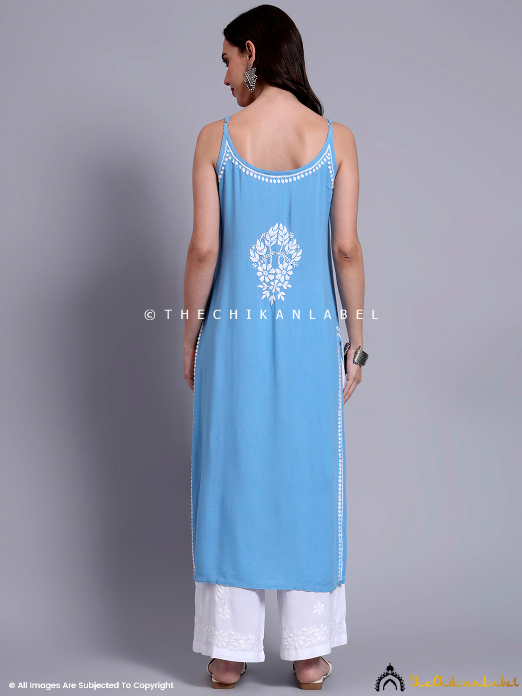 Indo-western festive look featuring a modal chikankari long kurta with traditional embroidery, styled for weddings and casual celebrations.

