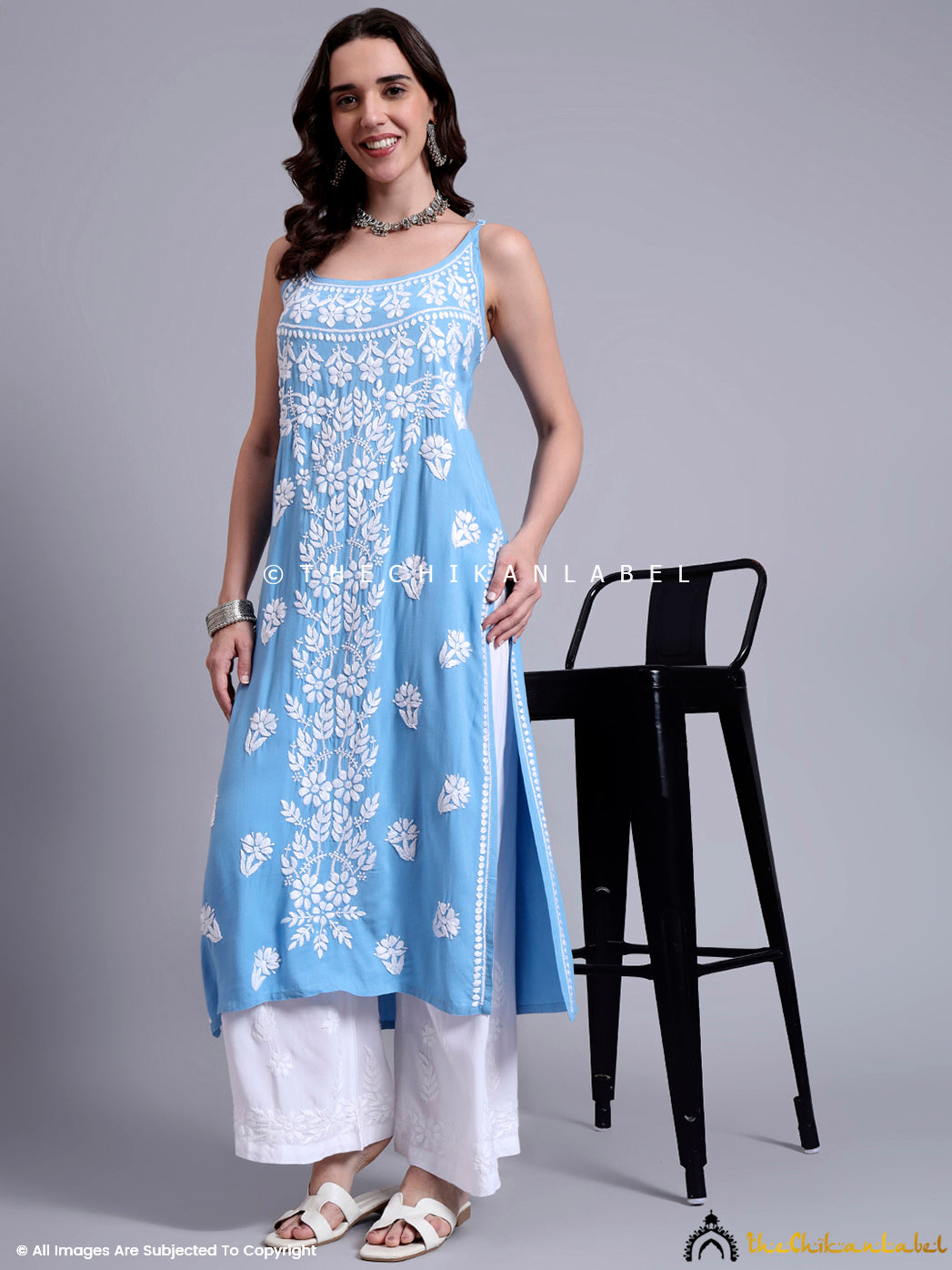 Flowing modal kurta with chikankari embroidery, styled with classic palazzo pants and festive jewelry, offering a blend of comfort and tradition.

