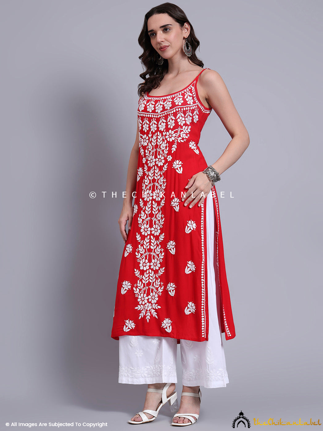 Ethnicwear outfit showcasing a strappy long kurta in soft modal fabric with floral hand embroidery, paired with wide-leg palazzo bottoms.

