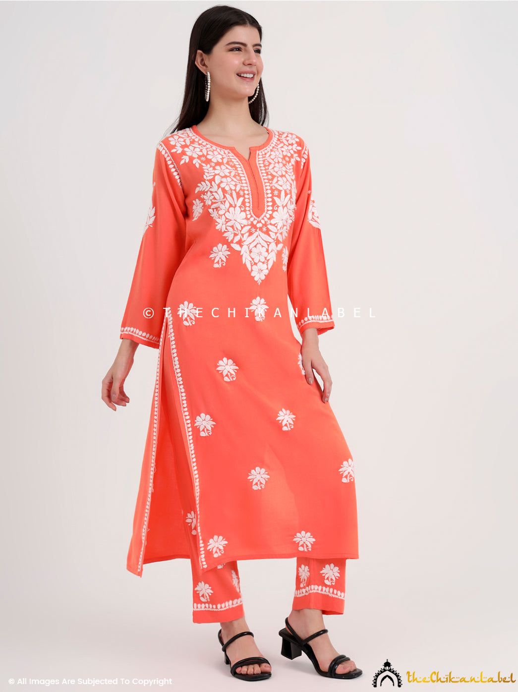 Ethnic chikankari kurti set with intricate neckline embroidery and scattered motifs across the fabric.