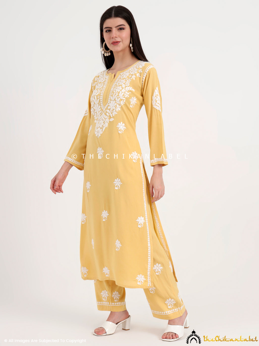 Hand-embroidered chikankari kurta set with detailed floral designs, ideal for casual gatherings and office wear.
