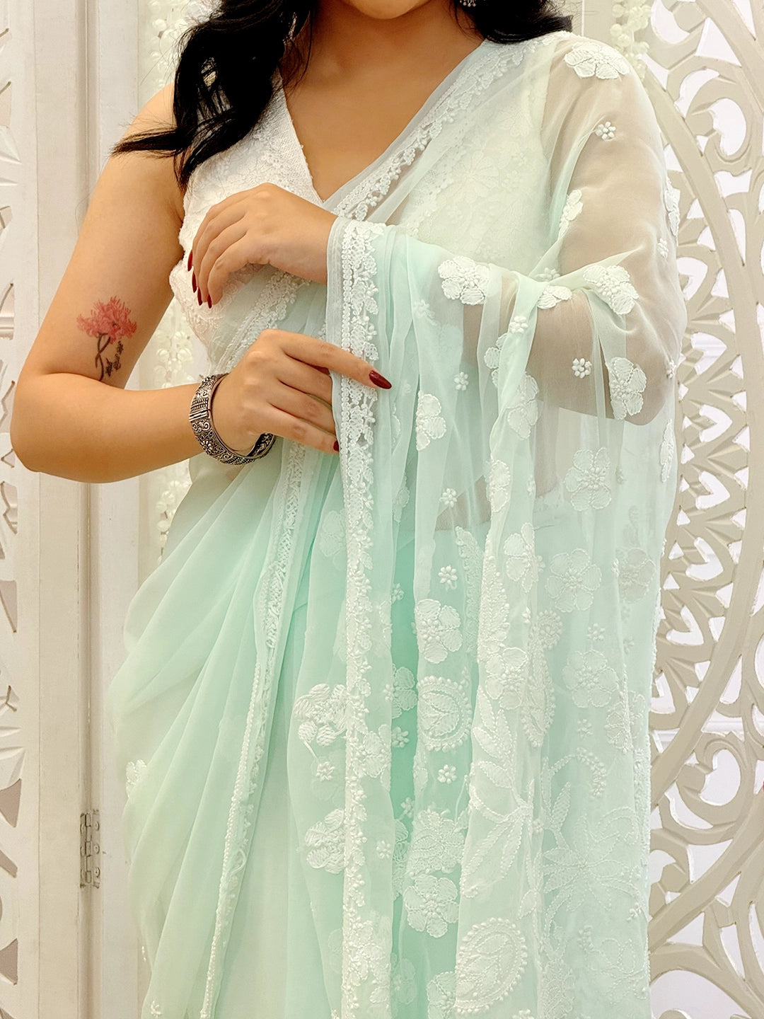 Traditional Lucknowi chikankari saree made from lightweight georgette fabric with handcrafted floral motifs.