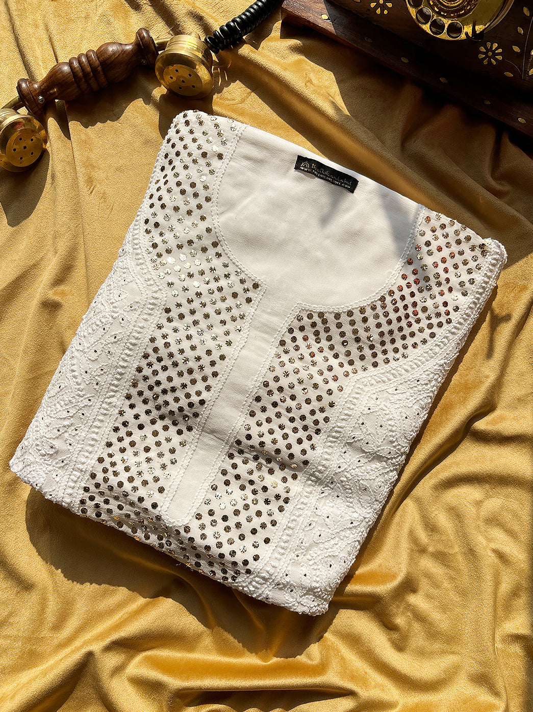 Elegant festive and ethnic wear viscose kurti piece with dupatta highlighted with shimmering mukaish embroidery.