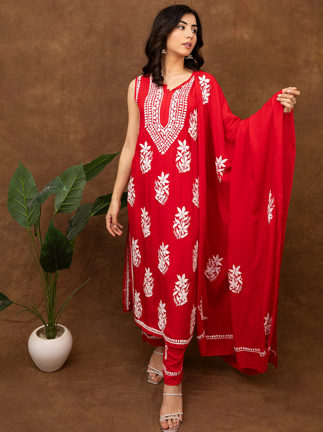 Authentic Lucknow chikankari kurta set featuring floral hand embroidery, sleeveless silhouette, matching pants, and dupatta for graceful ethnic styling