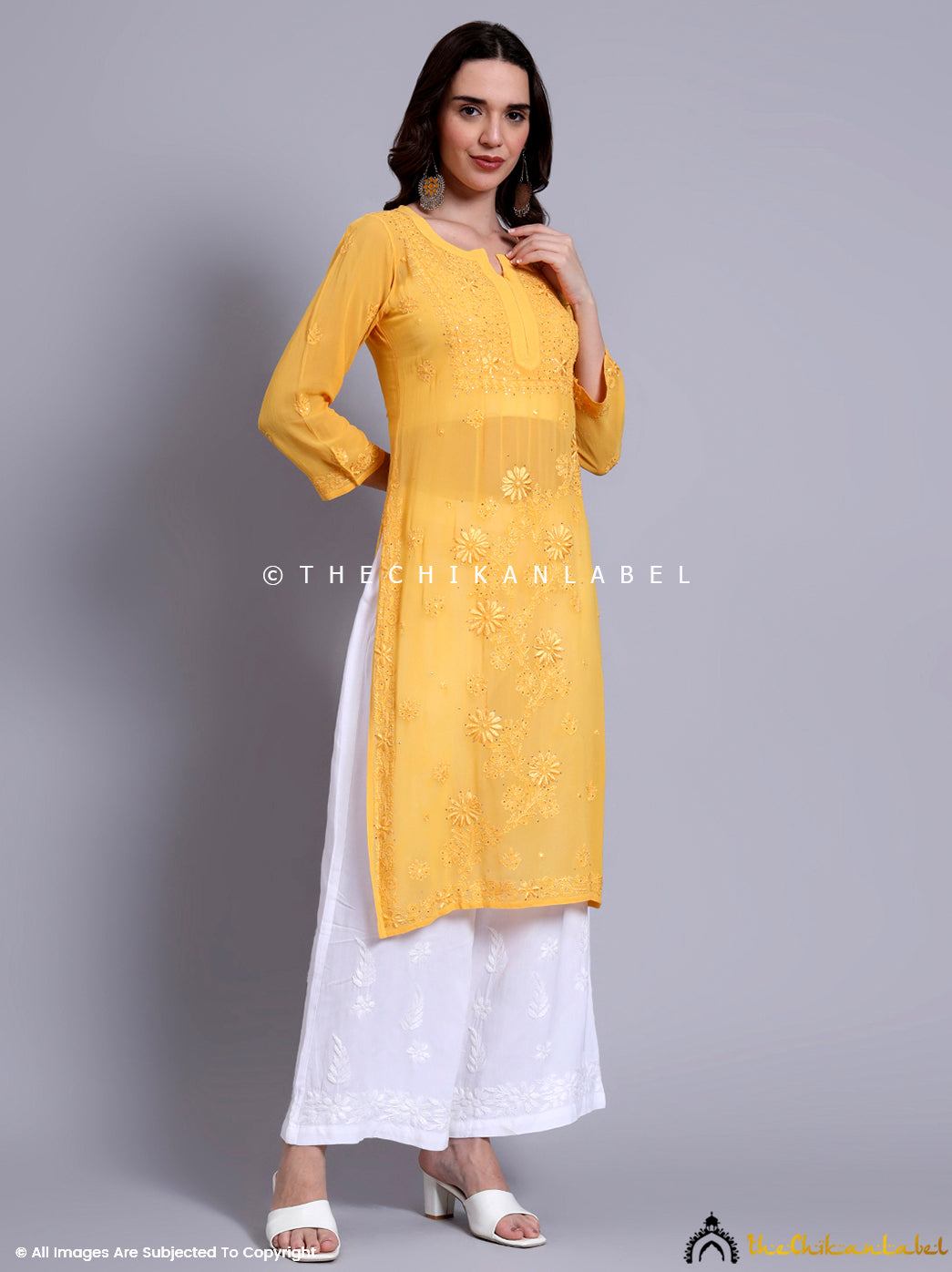 Side pose of model wearing trending Chikankari straight kurti designed in breathable viscose material.

