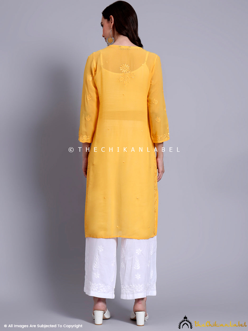 Close-up of traditional Chikankari motifs and mukaish embellishments on soft viscose kurti fabric.

