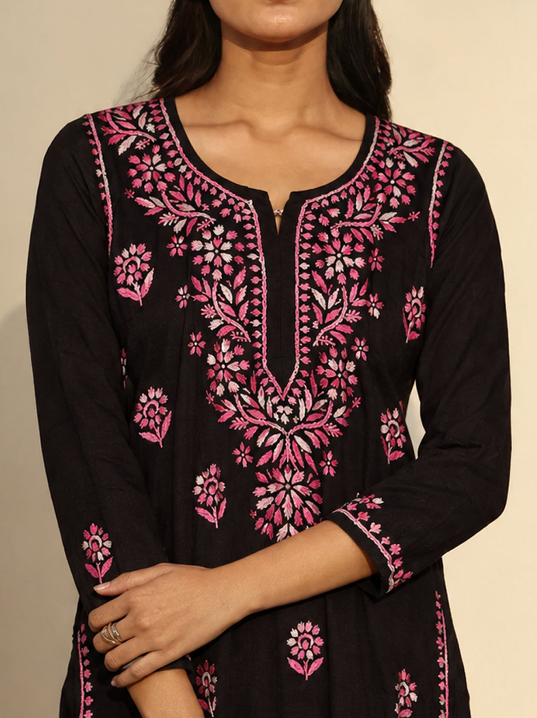 Ayra Rayon Straight Kurti paired with wide-leg jeans for casual styling, showing an elongated embroidered neckline panel, three-quarter sleeves and botanical borders along the front edges.
