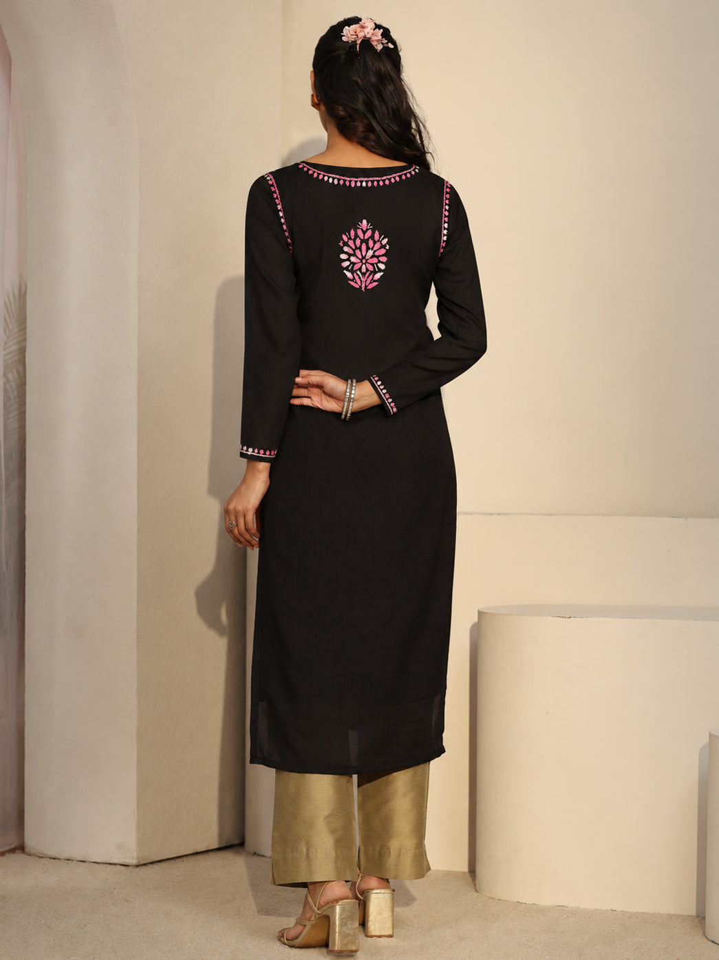 Front-facing model wearing a long Chikankari kurti by The Chikan Label, featuring a straight rayon silhouette, floral neckline embroidery and matching embroidered details on the cuffs and hem.
