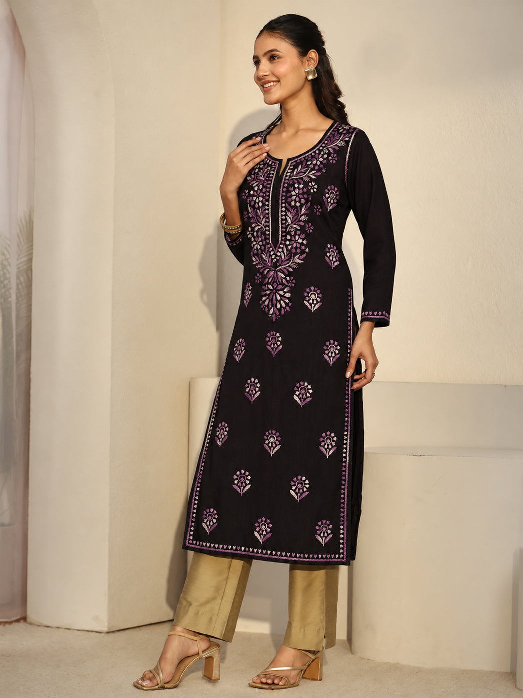 Ayra Rayon Straight Kurti paired with wide-leg jeans for casual styling, showing an elongated embroidered neckline panel, three-quarter sleeves and botanical borders along the front edges.